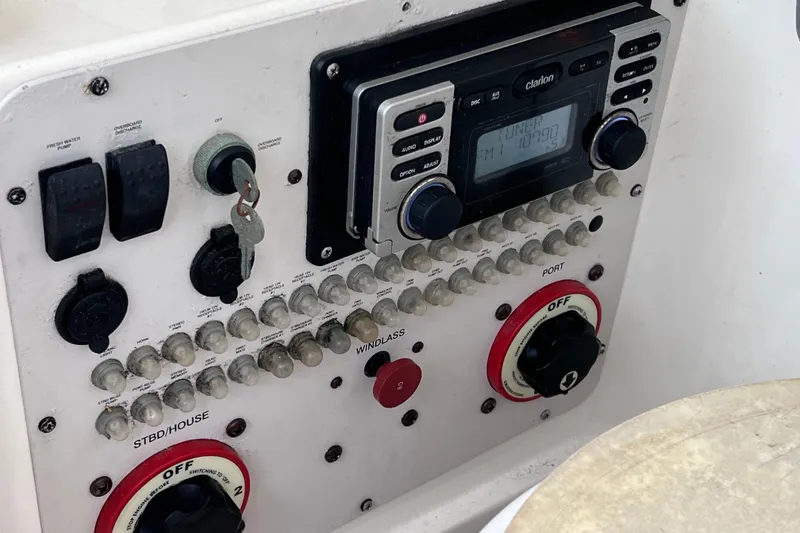 Slide: The Image of Control panel of a 2003 Wellcraft 29 CCF boat with radio and switches. - 50