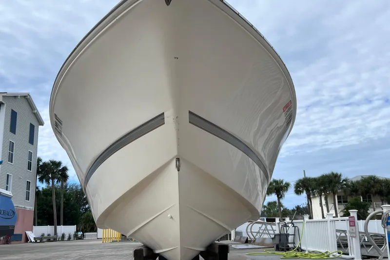 Slide: The Image of 2003 Wellcraft 29 CCF boat on dry dock, with clear sky background. - 8