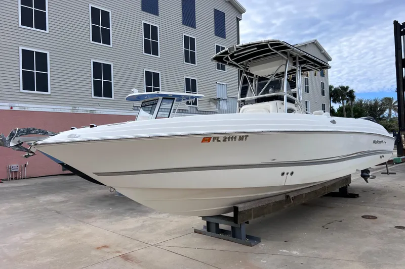 Slide: The Image of 2003 Wellcraft 29 CCF boat on display, docked near a building. - 9