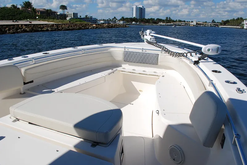 Slide: The Image of 2019 Cobia 344 Center Console boat with spacious seating on calm waters. - 11