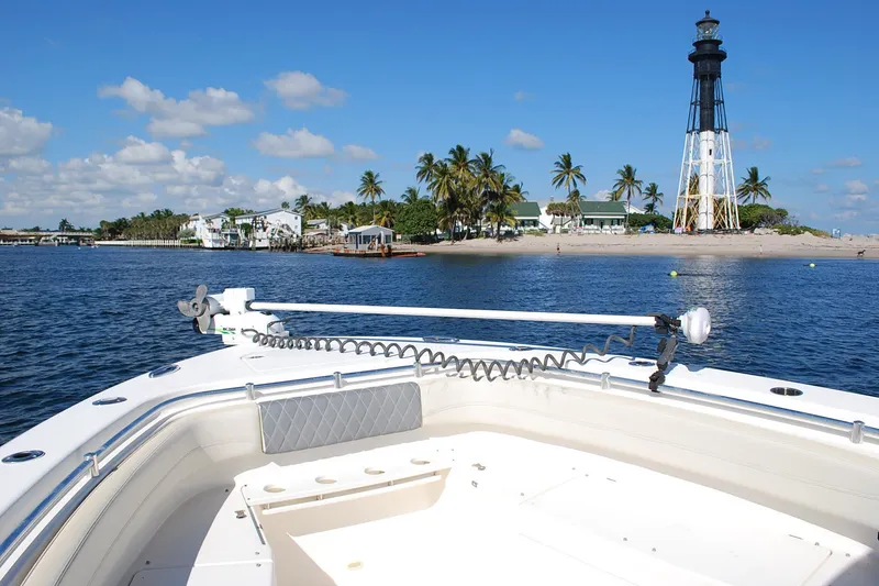 Slide: The Image of 2019 Cobia 344 Center Console boat near lighthouse and palm trees on a sunny day. - 12