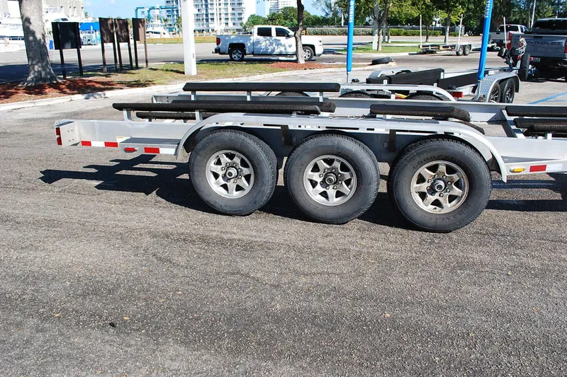 Slide: The Image of Triple-axle boat trailer for 2019 Cobia 344 Center Console in parking lot. - 22