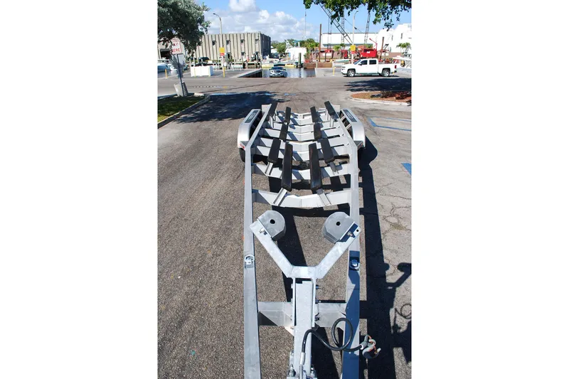 Slide: The Image of Empty boat trailer for 2019 Cobia 344 Center Console on a sunny day. - 24