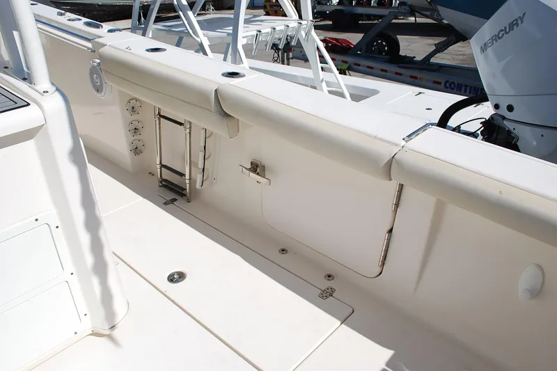 Slide: The Image of 2019 Cobia 344 Center Console boat interior with seating and Mercury engine. - 4