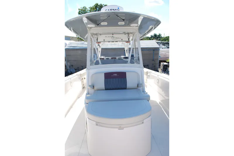 Slide: The Image of 2019 Cobia 344 Center Console boat with seating and canopy, docked outdoors. - 5