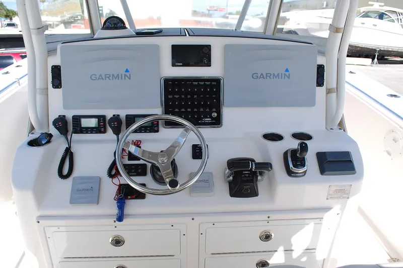 Slide: The Image of 2019 Cobia 344 Center Console helm with Garmin navigation and control systems. - 6