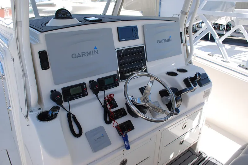 Slide: The Image of 2019 Cobia 344 Center Console helm with Garmin electronics and steering wheel. - 7