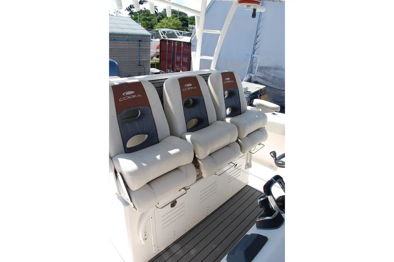 Slide: The Image of 2019 Cobia 344 Center Console boat with three cushioned seats. - 8