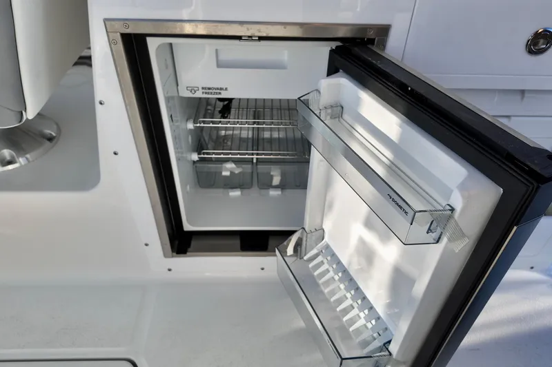Slide: The Image of Open refrigerator on 2026 Sea Fox 288 Traveler boat, showcasing interior storage space. - 18
