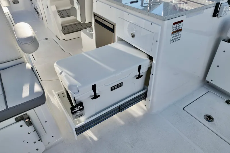 Slide: The Image of 2026 Sea Fox 288 Traveler boat interior with Yeti cooler in storage compartment. - 19
