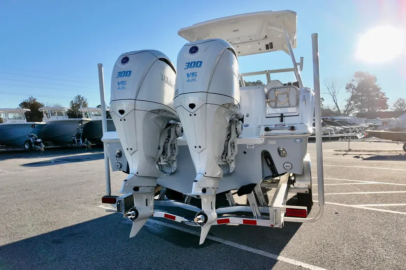 Slide: The Image of 2026 Sea Fox 288 Traveler with dual Yamaha 300 V6 engines in a sunny marina. - 24