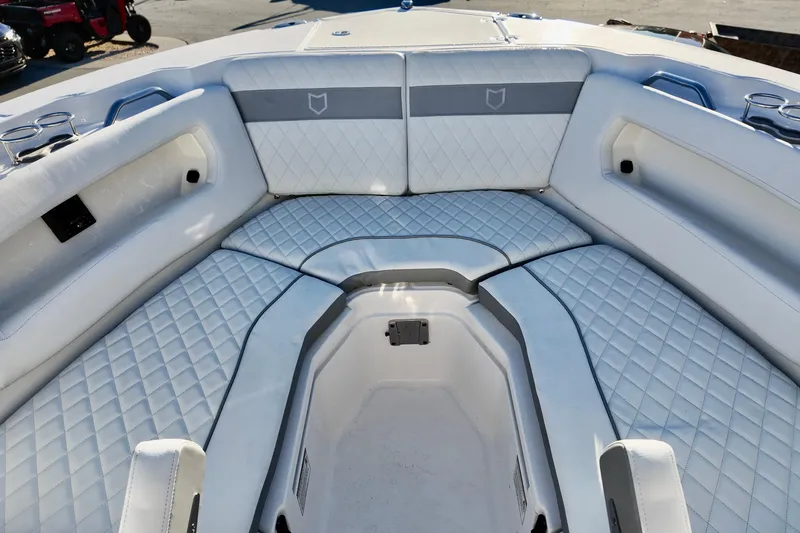 Slide: The Image of 2026 Sea Fox 288 Traveler boat interior with white quilted seating and cup holders. - 7
