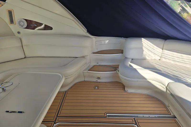 Slide: The Image of Interior of 2000 Sea Ray 540 Sundancer with white seating and wood flooring. - 16