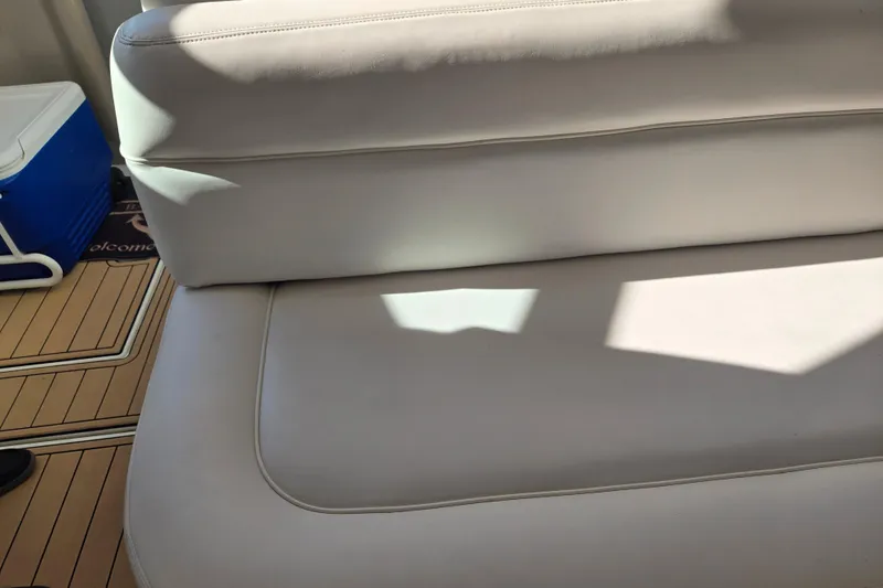 Slide: The Image of White leather seating on 2000 Sea Ray 540 Sundancer yacht, with cooler and wooden deck. - 20