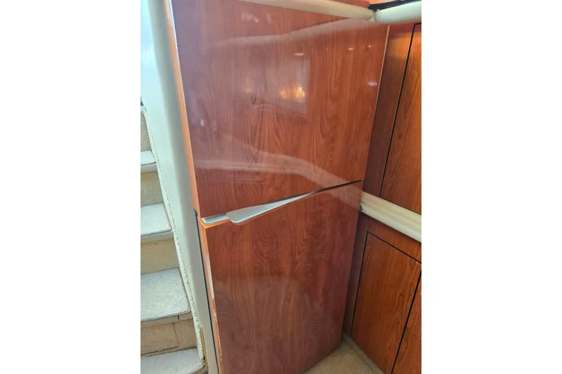 Slide: The Image of Wood-paneled refrigerator in 2000 Sea Ray 540 Sundancer yacht interior. - 44