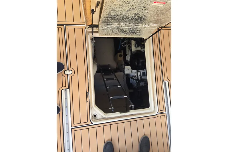 Slide: The Image of Engine compartment of 2000 Sea Ray 540 Sundancer with open hatch and visible machinery. - 59