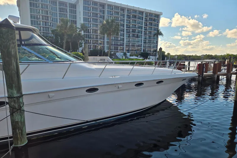 Slide: The Image of 2000 Sea Ray 540 Sundancer yacht docked near waterfront buildings. - 6