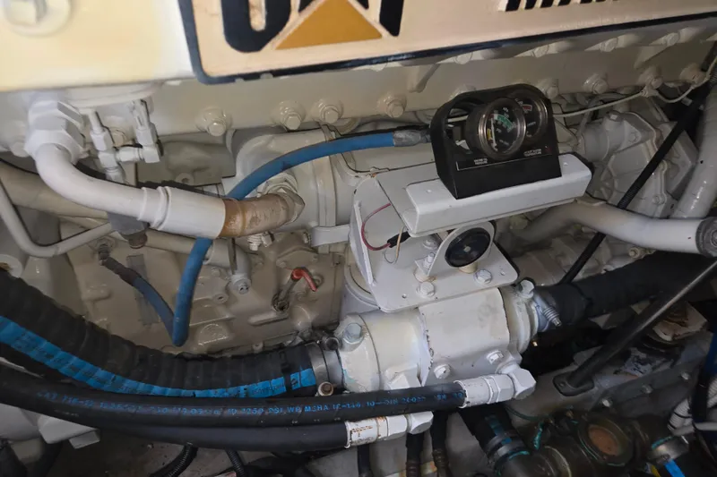 Slide: The Image of Engine compartment of 2000 Sea Ray 540 Sundancer with visible gauges and hoses. - 69