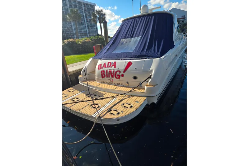 Slide: The Image of 2000 Sea Ray 540 Sundancer docked, rear view with "Bada Bing" name visible. - 7