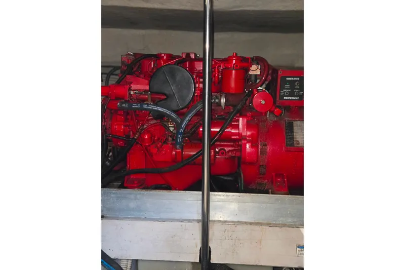 Slide: The Image of Engine compartment of a 2000 Sea Ray 540 Sundancer, featuring a red marine engine. - 72