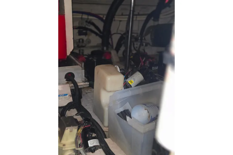 Slide: The Image of Engine room of 2000 Sea Ray 540 Sundancer with various mechanical components and containers. - 73