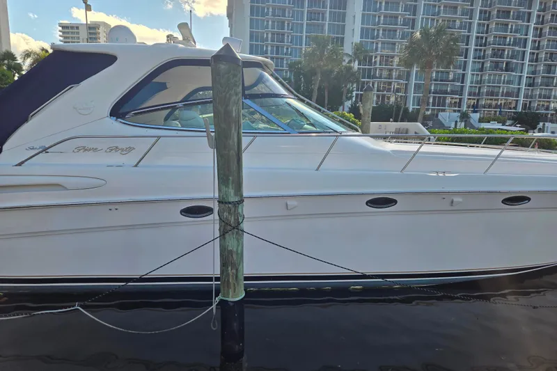 Slide: The Image of 2000 Sea Ray 540 Sundancer yacht docked near waterfront buildings. - 9