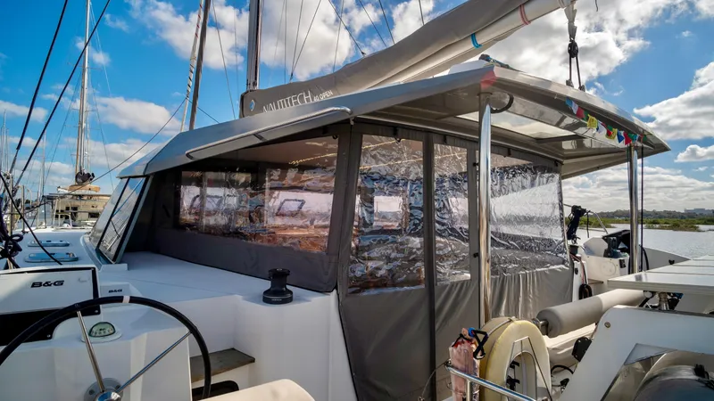Slide: The Image of Nautitech 40 Open 2019 catamaran with enclosed cabin and sails. - 13