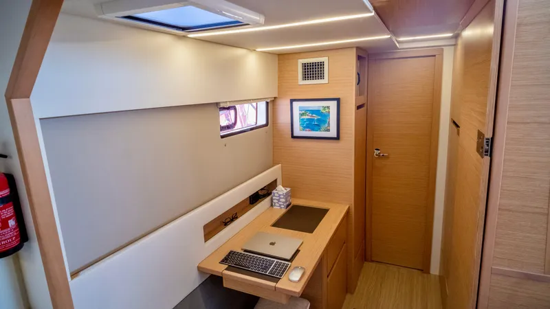 Slide: The Image of Interior of 2019 Nautitech 40 Open with desk and laptop. - 31