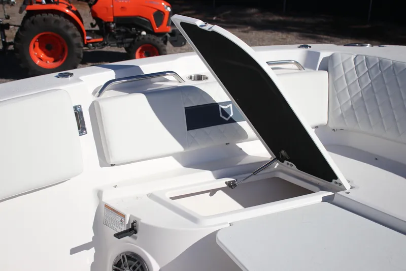 Slide: The Image of 2026 Sea Fox 268 Commander boat interior with open storage compartment, white seating, and visible tractor. - 21