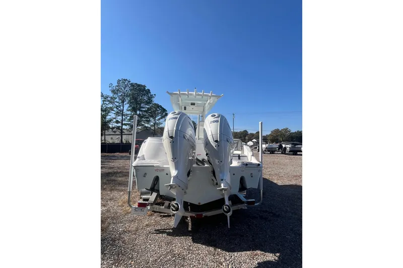 Slide: The Image of 2026 Sea Fox 268 Commander boat with dual outboard engines, parked on gravel. - 26