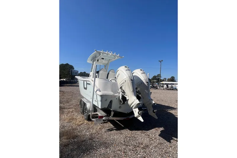 Slide: The Image of 2026 Sea Fox 268 Commander boat on trailer, side view, clear blue sky background. - 5