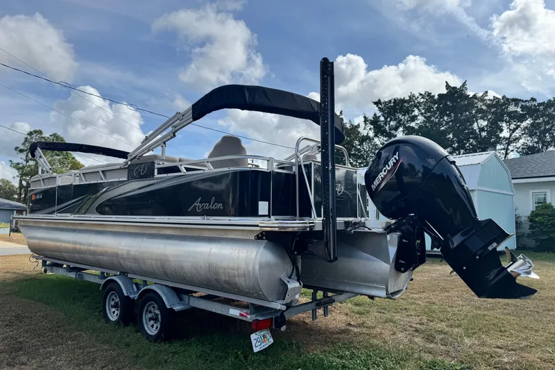 The Image of 2022 Avalon GS Rear Fish 25' pontoon boat with Mercury outboard motor on trailer. - 0