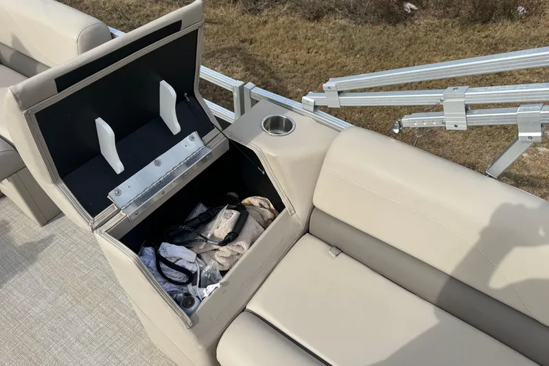 Slide: The Image of Open storage compartment on 2022 Avalon GS Rear Fish boat with beige seating. - 12