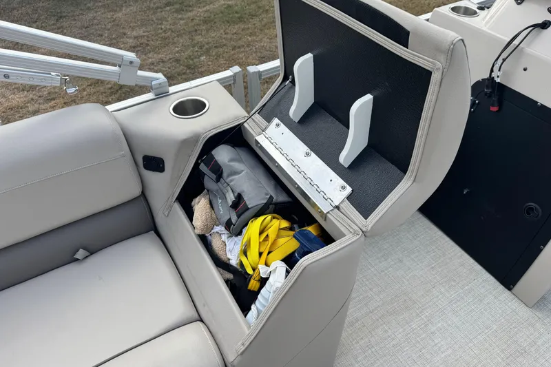 Slide: The Image of 2022 Avalon GS Rear Fish 25' boat seat storage with cup holder and gear inside. - 13