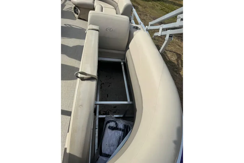 Slide: The Image of 2022 Avalon GS Rear Fish 25' boat with open storage under beige seating. - 14