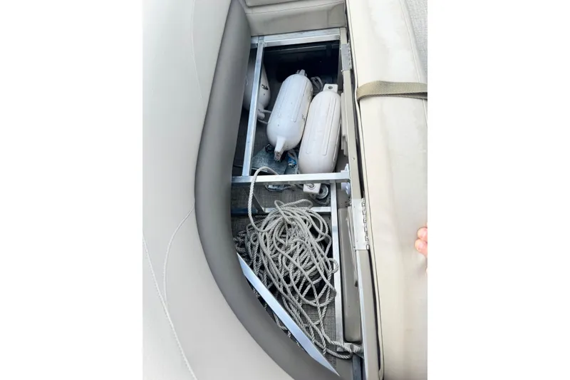 Slide: The Image of Storage compartment in 2022 Avalon GS Rear Fish 25' boat with ropes and fenders. - 15