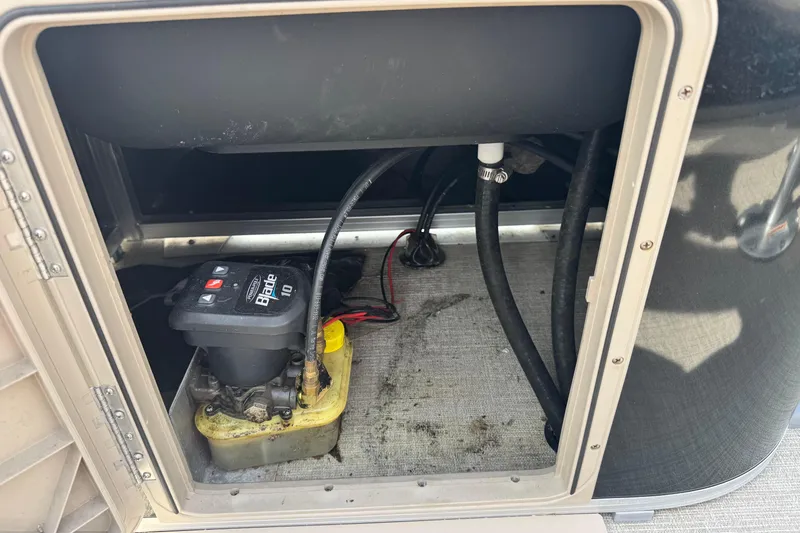 Slide: The Image of 2022 Avalon GS Rear Fish 25' boat compartment with battery and wiring. - 18