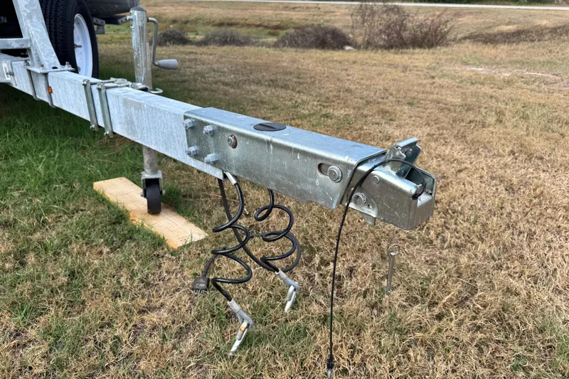 Slide: The Image of Trailer hitch of 2022 Avalon GS Rear Fish - 25' on grassy field. - 31