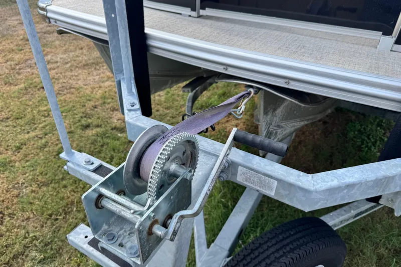 Slide: The Image of 2022 Avalon GS Rear Fish boat trailer winch mechanism on grassy area. - 32