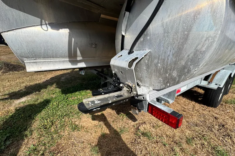 Slide: The Image of 2022 Avalon GS Rear Fish 25' boat trailer hitch on grassy ground. - 33