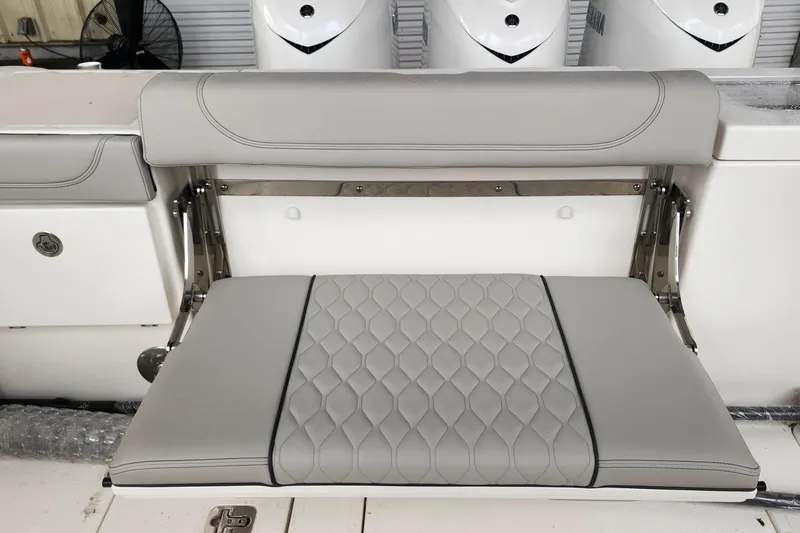 Slide: The Image of 2026 Pursuit OS 355 Offshore boat seat with quilted gray upholstery and cup holders. - 10