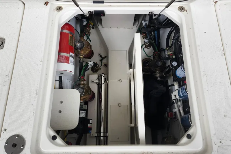 Slide: The Image of 2026 Pursuit OS 355 Offshore boat deck with storage compartments and fishing rod. - 12