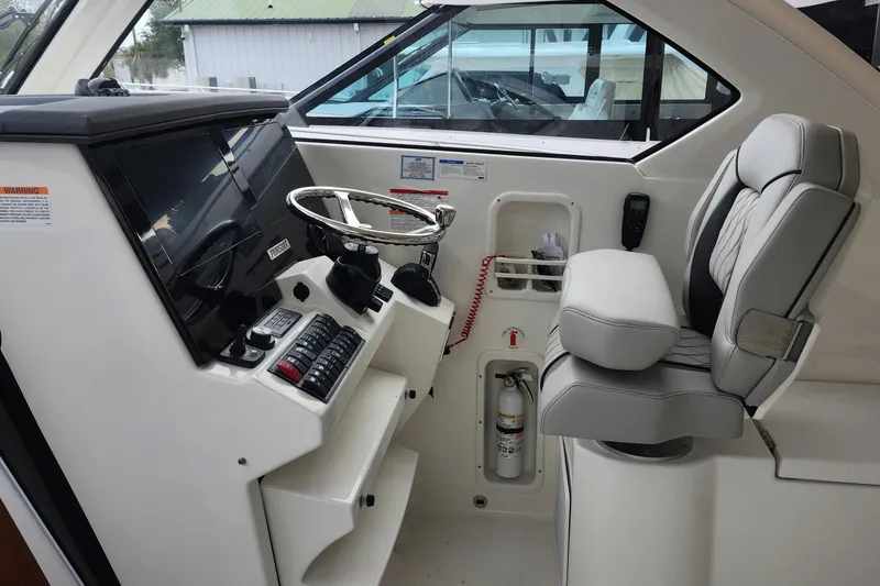 Slide: The Image of 2026 Pursuit OS 355 Offshore storage compartment with bucket and control panel. - 19