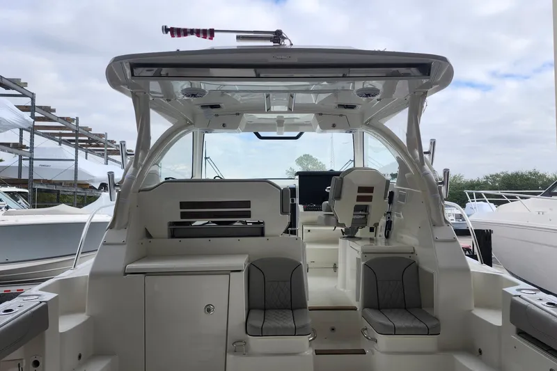 Slide: The Image of 2026 Pursuit OS 355 Offshore boat docked at marina with Yamaha engines. - 2