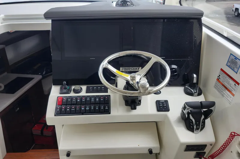 Slide: The Image of Electrical control panel on a 2026 Pursuit OS 355 Offshore boat. - 20