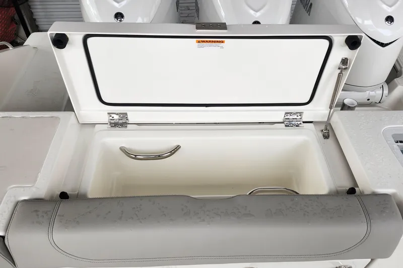 Slide: The Image of 2026 Pursuit OS 355 Offshore boat front view in a storage facility. - 8