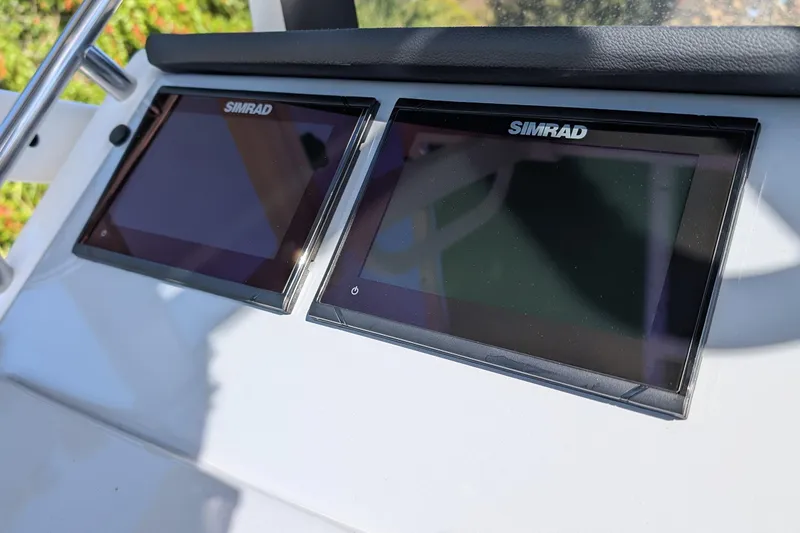 Slide: The Image of Simrad displays on 2026 Bayliner Trophy T20CC boat dashboard. - 10