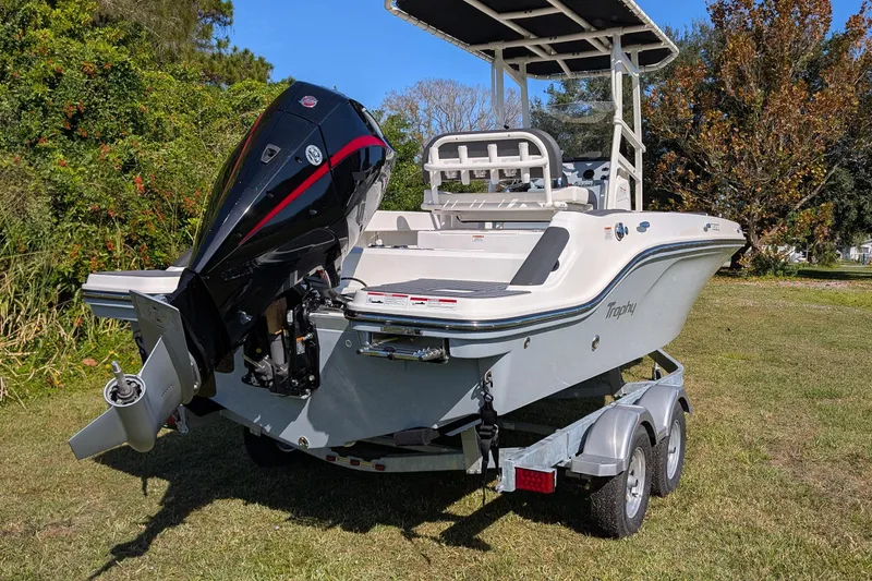 Slide: The Image of 2026 Bayliner Trophy T20CC boat on trailer, featuring powerful outboard motor. - 4