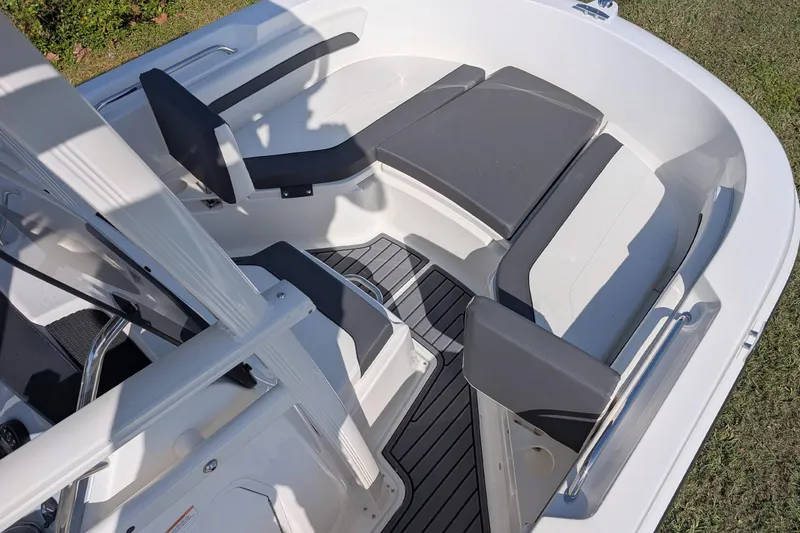 Slide: The Image of 2026 Bayliner Trophy T20CC boat interior with cushioned seating and sleek design. - 9