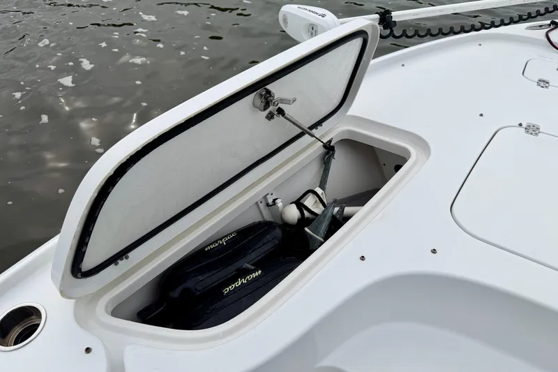Slide: The Image of Open storage compartment on 2022 Sea Hunt BX 22 BR boat, showing equipment inside. - 11